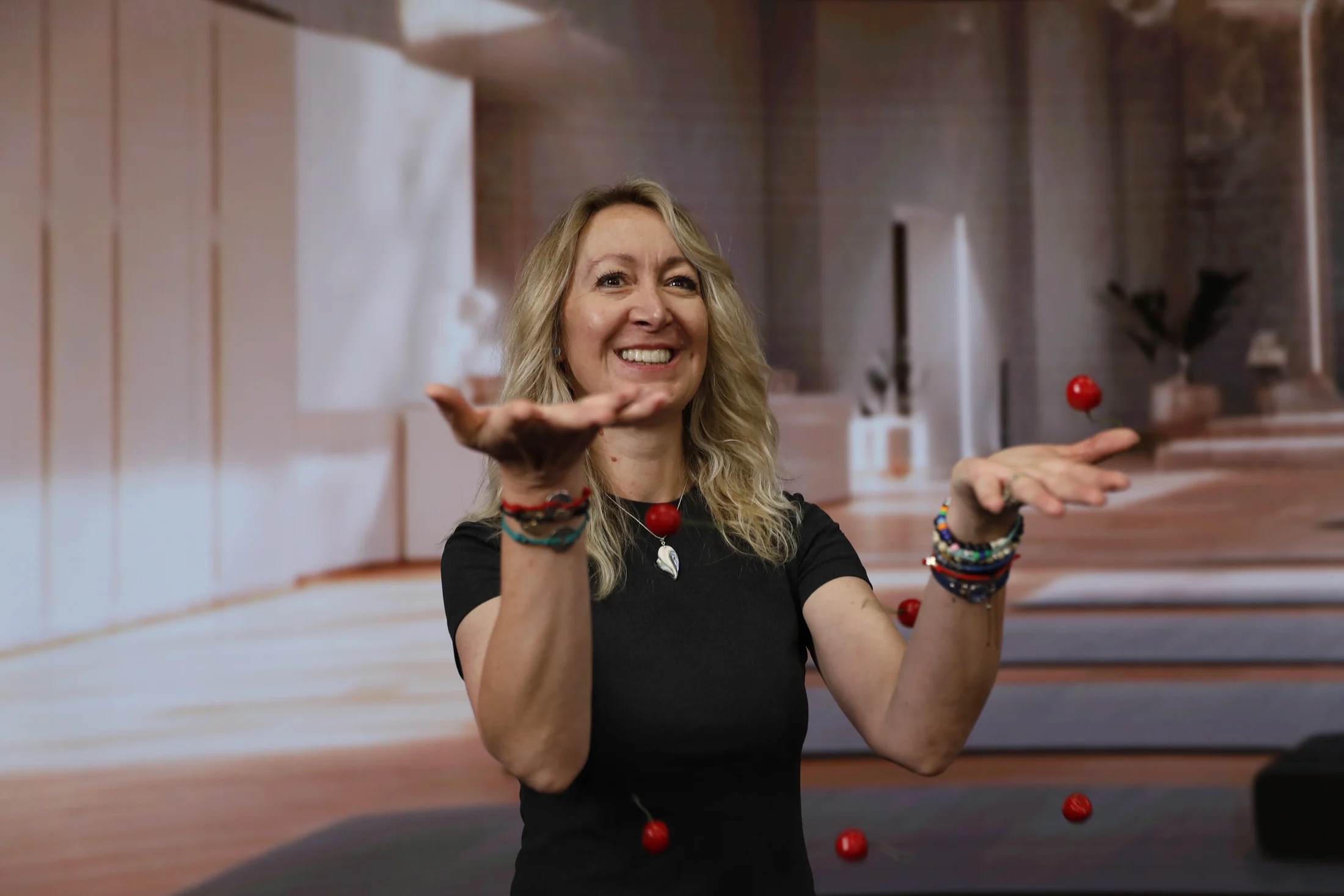 Andrea Limbach smiling as cherries float around her