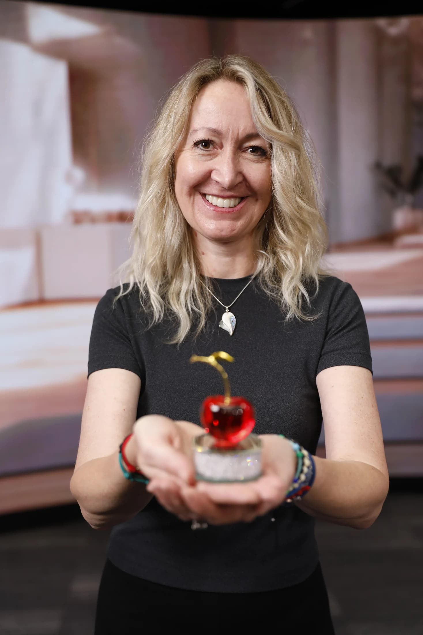Andrea Limbach smiling and holding a cherry
